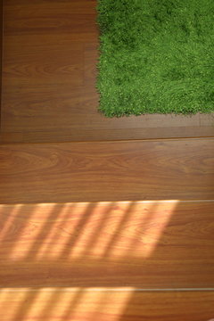 green carpet covering on laminate wooden stair © sutichak