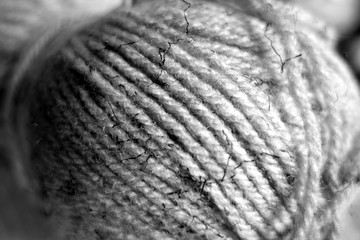 Yarn ball close-up with blur effect in black and white.