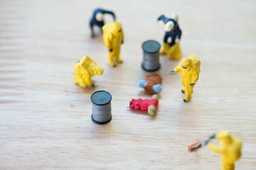 Miniature crime scene investigator with backpack on ground