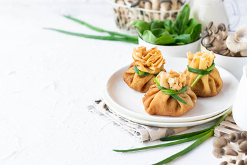 Pancake bags stuffed with with fried oyster mushrooms with spinach