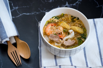Seafood and pork sukiyaki in white bowl