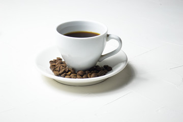 Coffee cup and coffee beans on wooden background. Top view.