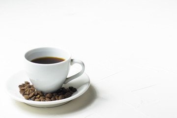 Coffee cup and coffee beans on wooden background. Top view.