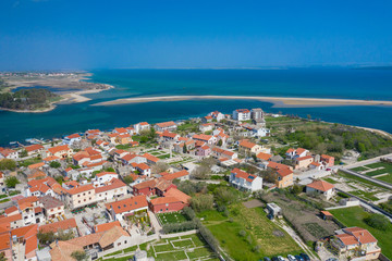 Naklejka na ściany i meble Aerial view of city of Nin. Summer time in Dalmatia region of Croatia. Coastline and turquoise water and blue sky with clouds. Photo made by drone from above.