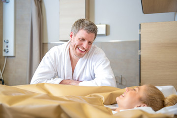 young beautiful woman are doing a fango therapie in a wellness area. friends are on the side of the water bed