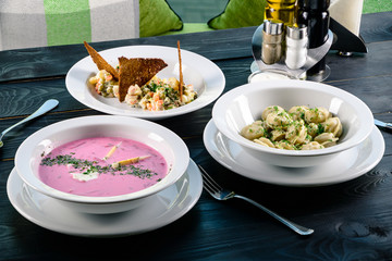 Enjoy your meal. Set of three delicious dishes served on a restaurant table - obrazy, fototapety, plakaty