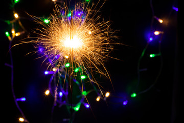 sparkler with blur new year's light close up