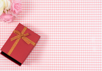 gift box with red isolated on Plaid background. Holiday decoration for Mother's Day or Women's Day.