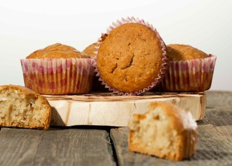 homemade muffins with coconut chips on a wooden stand