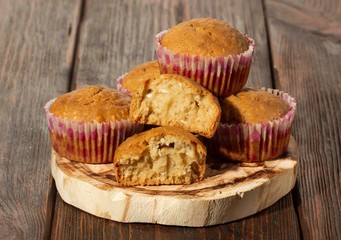 Vanilla cupcake, homemade pastry on wooden background