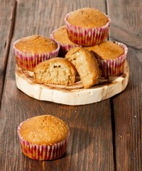 Vanilla cupcake, homemade pastry on wooden background