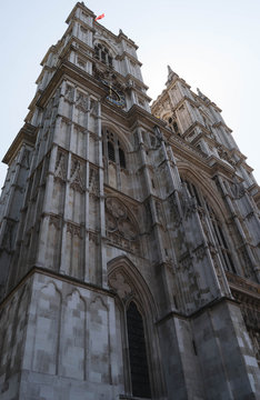 Westminster abbey, a gothic church from below looking high up to the sky in a standing picture format.