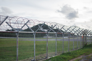 wire mesh steel with green grass background in Phuket Thailand