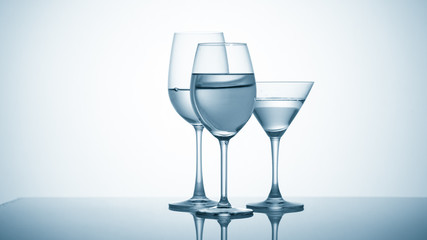 Glasses with water on blue background
