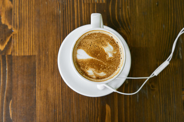 Cup of hot coffee latte on a wooden table