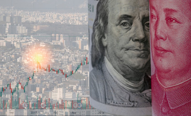 US dollar and Yuan banknote with stock investment graph and skyscraper building. Its is symbol for tariff trade war crisis between biggest economic country in the world.