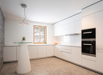 Interior of modern white and empty kitchen.