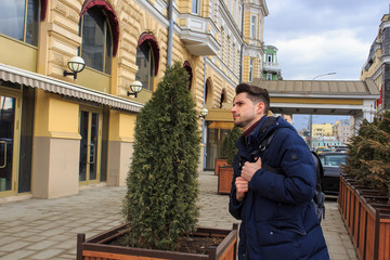 The young man is waiting for someone very much and he is very happy at this meeting