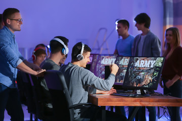 Young people playing video games at tournament