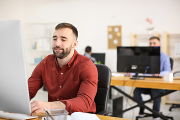 Young man working in office. Finance trading