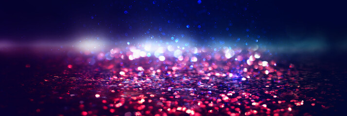 glitter vintage lights background. black, gold, purple, blue and red. de-focused