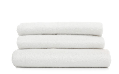 Stack of clean folded towels on white background