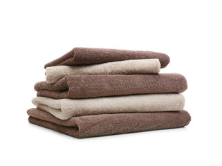 Stack of clean folded towels on white background