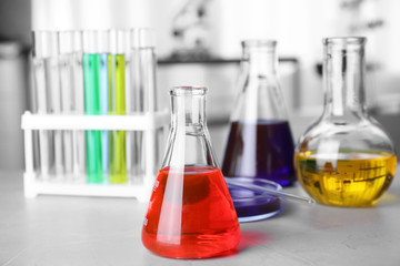 Laboratory glassware with samples on table indoors, space for text. Solution chemistry