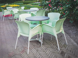 Fototapeta na wymiar Spring garden with outdoor furniture on the terrace of a cafe in the Netherlands. The concept of rest.