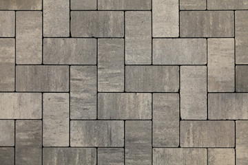Paving slabs of gray blocks regular shape close-up. New pavement in the city park