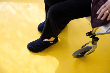 shoes on the floor, woman sitting in a wheelchair