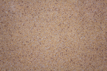 white gray granular surface of the wall with yellow, red and black dots. rough texture