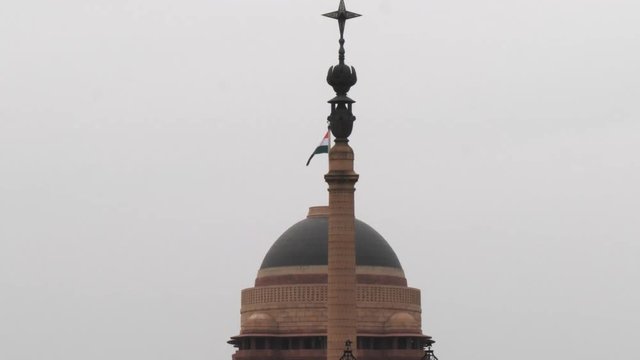 a close up of the dome of the indian president's house and flag in new delhi- 4K 60p, india