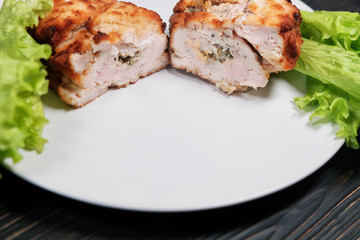 Chicken cutlet with lettuce leaves. Chops stuffed with greens, cheese and butter. Fried to a crisp chicken cutlet.