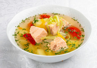 Soup with salmon and vegetables. On white background