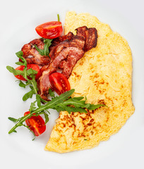 Omelet with bacon and tomatoes on white background