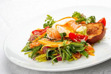 Poached egg with croutons and vegetable salad on white background