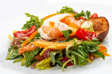 Poached egg with croutons and vegetable salad on white background
