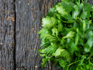 Fresh parsley leaves on wooden background. Top view