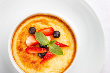 Baked cottage cheese dessert with strawberry on white background
