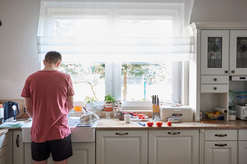 Caucasian man washing dish at kitchen - Powered by Adobe
