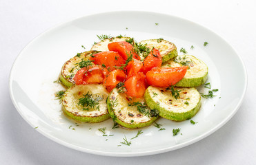 Grilled zucchini with tomatoes on white background