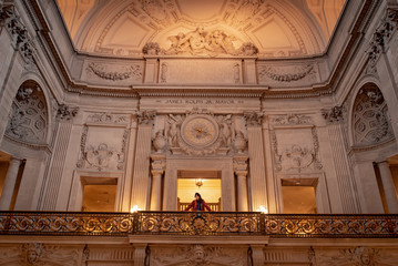 Asian woman standing in San Francisco City Hall, one of travel attractions where reconstruction...