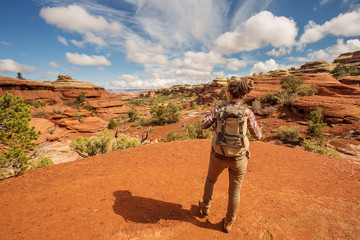 Hiker in Canyonlands National park, needles in the sky, in Utah, USA