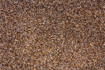 A surface is studded by little varicoloured pebbles..