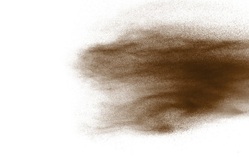 Freeze motion of brown dust explosion. Stopping the movement of brown powder. Explosive brown powder on white background.
