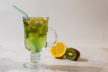 Refreshing lemonade from kiwi and lemon on a light background. Horizontal orientation