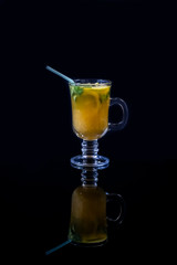 Freshly squeezed orange juice with pulp, kiwi and lemon on a dark background. Vertical orientation