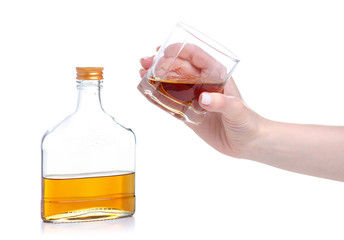 Glass with cognac and bottle cognac on a white background. Isolation