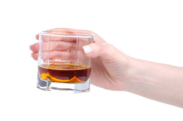 Glass with cognac brandy alcohol in hand on a white background. Isolation